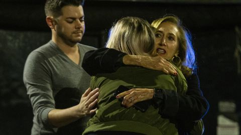 Matthew Rodin, left, and Susan Turner comfort Melissa Hutchinson who rendered aid to some of the victims.
