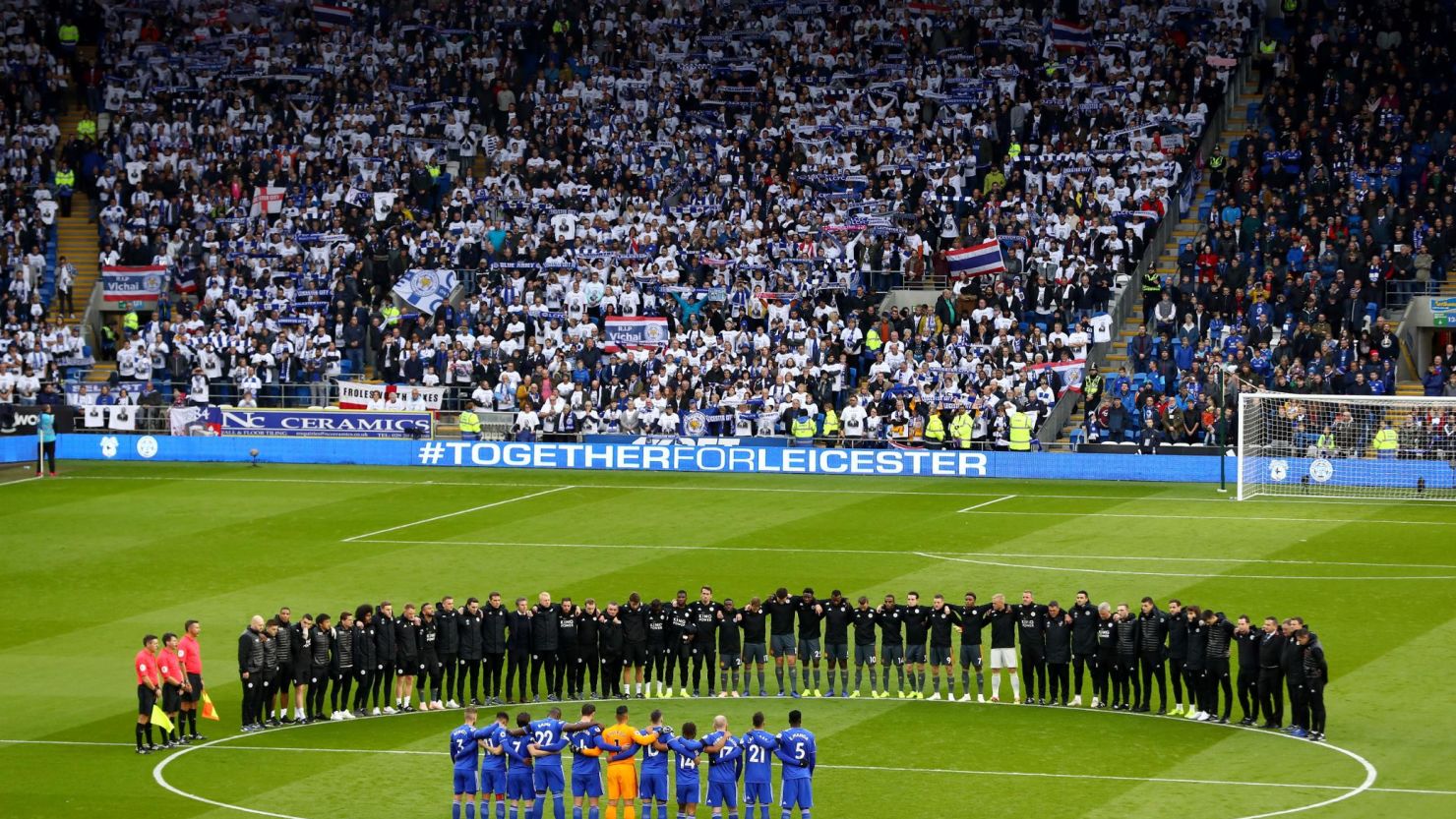 Leicester City and staff line up around the center circle for a minute's silence for Vichai Srivaddhanaprabha prior to the club's match against Cardiff City.