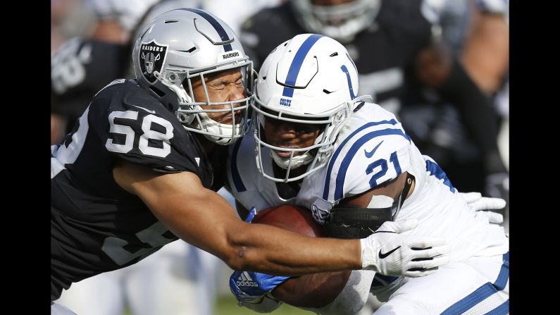 Oakland Raiders linebacker Kyle Wilber attempts to tackle Indianapolis Colts running back Nyheim Hines during the second half of an NFL football game in Oakland, California Sunday, October 28, 2018.