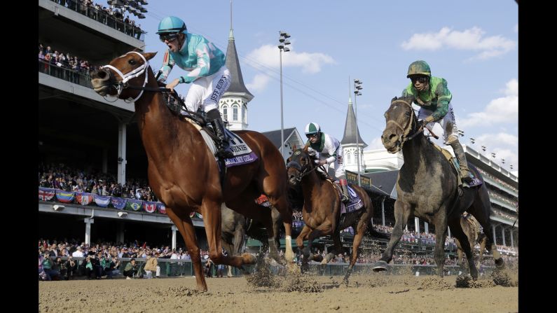 Florent Geroux, left, celebrates as he rides Monomoy Girl to victory in the Breeders' Cup Distaff horse race at Churchill Downs, Saturday, November 3, 2018, in Louisville, Kentucky. 