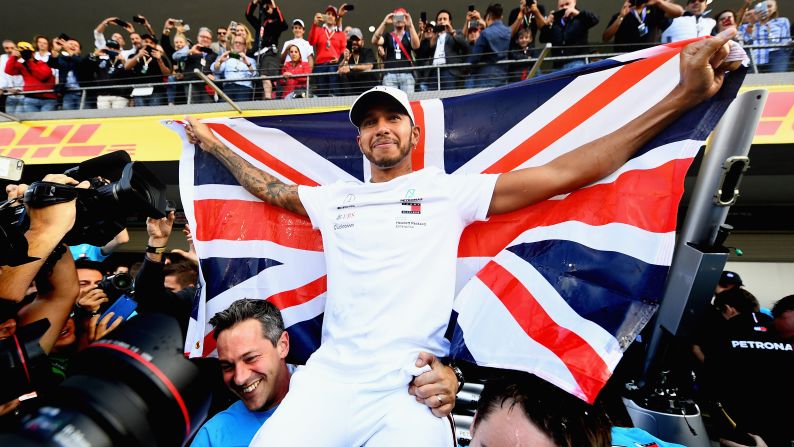 Lewis Hamilton of Great Britain celebrates with his team after winning the Formula One Grand Prix of Mexico on October 28 in Mexico City. Hamilton became just the third driver in history to win five or <a href="index.php?page=&url=https%3A%2F%2Fwww.cnn.com%2F2018%2F10%2F29%2Fmotorsport%2Flewis-hamilton-fifth-world-title-formula-one-great-spt-intl%2Findex.html" target="_blank">more career Formula One world titles</a>.