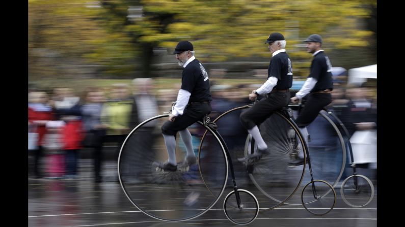 Enthusiasts dressed in historical costumes enjoy a ride on penny-farthing bicycles during their traditional race in Prague, Czech Republic on November 3, 2018. 