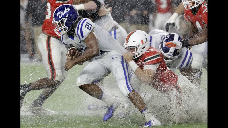 Miami defensive lineman Scott Patchan attempts to tackle Duke running back Mataeo Durant during the first half of an NCAA football game on November 3 in Miami Gardens, Florida. The Blue Devils defeated the Hurricanes 20-12.