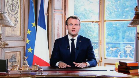 A photo taken on November 4, 2018 in Paris shows a TV screen displaying French President Emmanuel Macron delivering a speech after the results from an independence referendum in the French Pacific territory of New Caledonia.