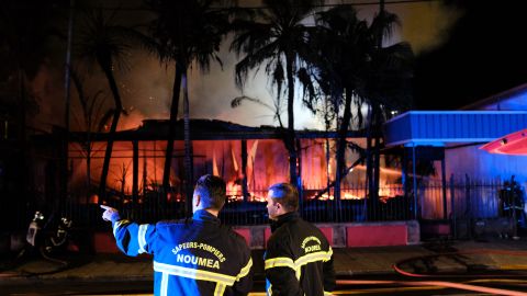 Firefighters try to extinguish a house set on fire in downtown Noumea overnight on November 5, 2018, after the results from an independence referendum in the French Pacific territory of New Caledonia.
