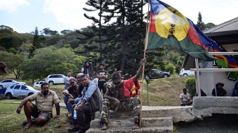 An activist holds the pro-independant flag during a meeting of the Kanak and Socialist National Liberation Front (FLNKS) campaign for a 'yes' to New Caledonia's independence from France in Noumea.