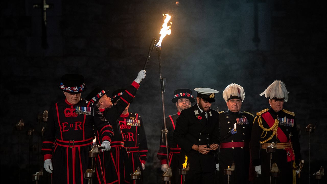 <strong>Carrying the torch:</strong> After the bugle call, the yeoman warders, in their traditional uniforms, begin the torch lighting ceremony.