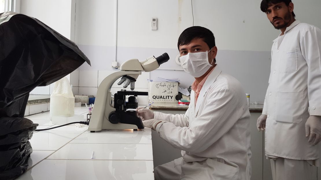 Lab staff at the Antoni hospital examine a urine sample.