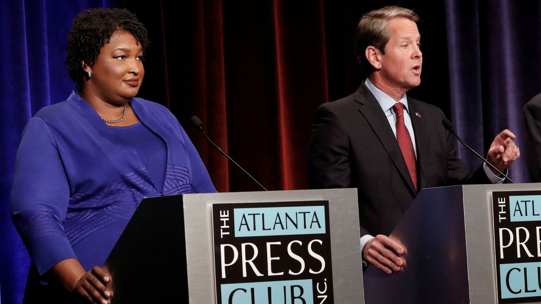 Republican gubernatorial candidate Brian Kemp speaks as Democratic rival Stacey Abrams looks on during a debate in Atlanta on October 23, 2018. 