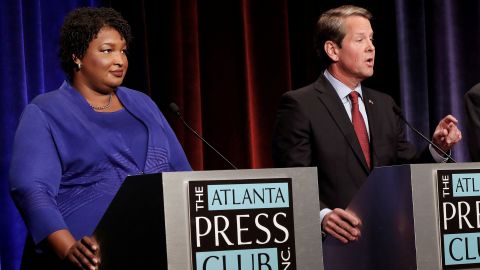 Republican gubernatorial candidate Brian Kemp speaks as Democratic rival Stacey Abrams looks on during a debate in Atlanta on October 23, 2018.