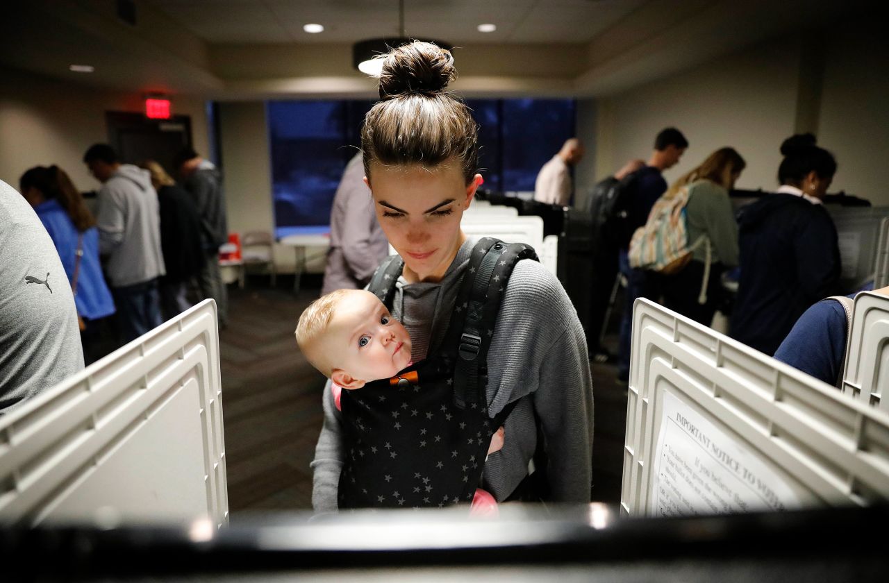 Kristen Leach votes with her 6-month-old daughter, Nora, in Atlanta.