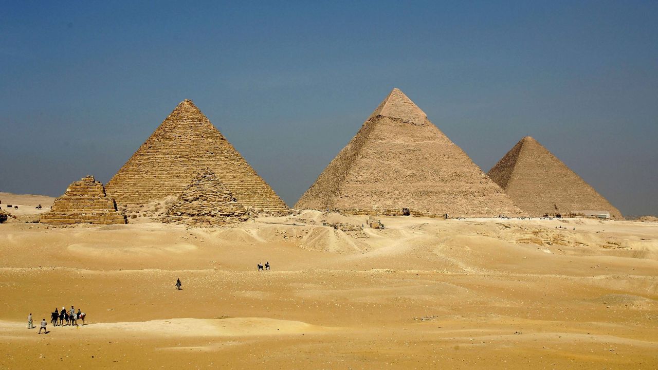 Three enormous pyramids loom over the horizon at Giza.