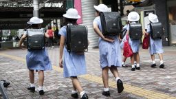 TOPSHOT - Schoolgirls walk home at Ebisu district in Tokyo on September 4, 2017. / AFP PHOTO / Behrouz MEHRI        (Photo credit should read BEHROUZ MEHRI/AFP/Getty Images)