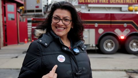 Rashida Tlaib points to her 'I voted' sticker after voting during the midterm election in Detroit.