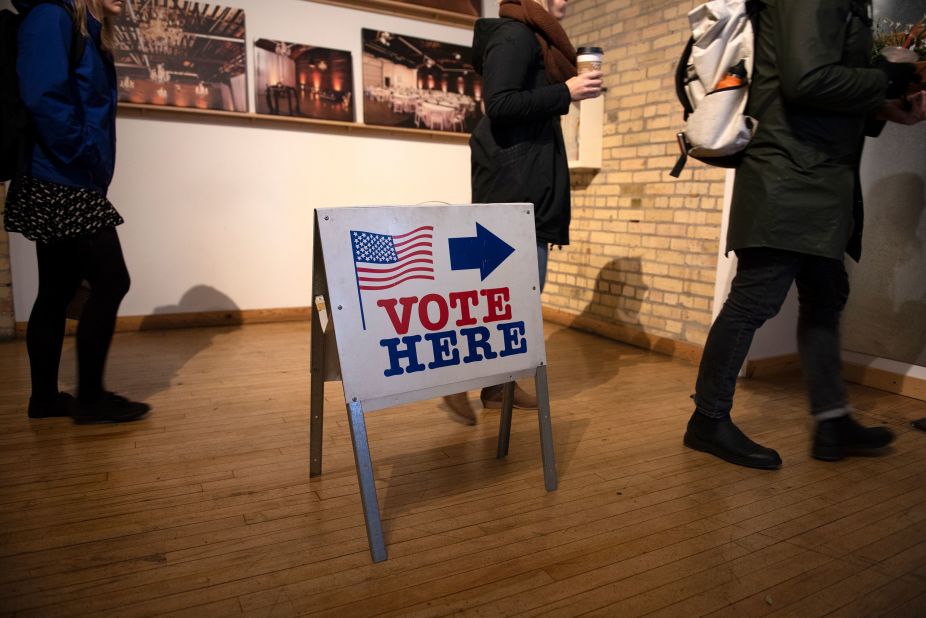 A sign guides voters to the polls in Minneapolis.