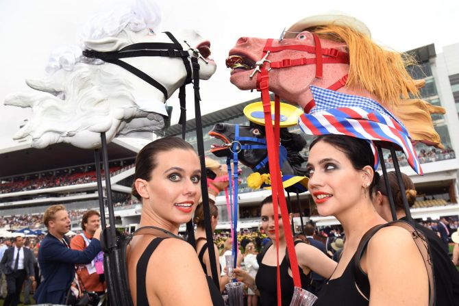 Heavy rain did nothing to dampen the spirit of race-goers, some of whom wore figures of horse heads ahead of the running of the Melbourne Cup.