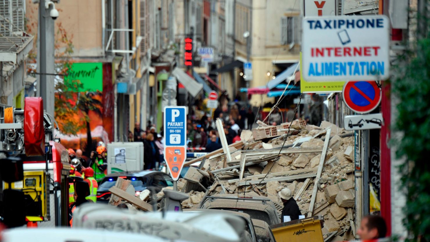 Authorities stand guard inside a security perimeter set around the Marseille buildings collapse.