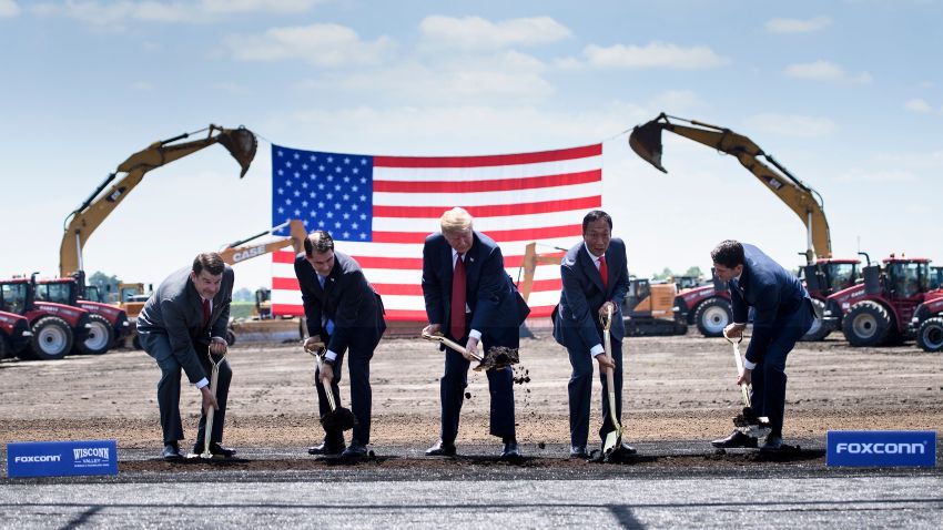 TOPSHOT - Wisconsin Governor Scott Walker (2nd L), US President Donald Trump (C), Foxconn Chairman Terry Gou (2nd R), Speaker of the House Paul Ryan (R) and an unidetified official (L) participate in a groundbreaking for a Foxconn facility at the Wisconsin Valley Science and Technology Park on June 28, 2018 in Mount Pleasant, Wisconsin.