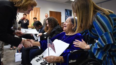 Valles receives her certificate as her daughter, Bernarda Bonilla, looks on.