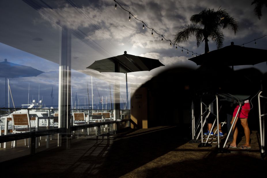 Boats are reflected in a window as voters cast ballots in Newport Beach, California.