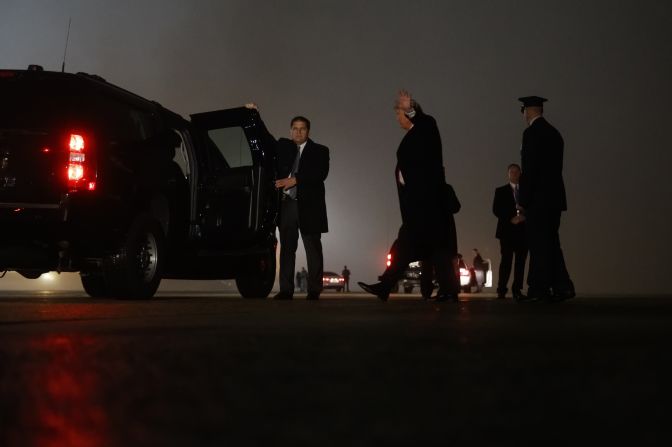 After attending campaign rallies in Indiana, Missouri and Ohio, President Donald Trump waves after arriving back in Washington on Tuesday evening.