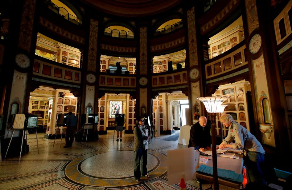 An elections official, right, registers a voter at the Neptune Society Columbarium in San Francisco.