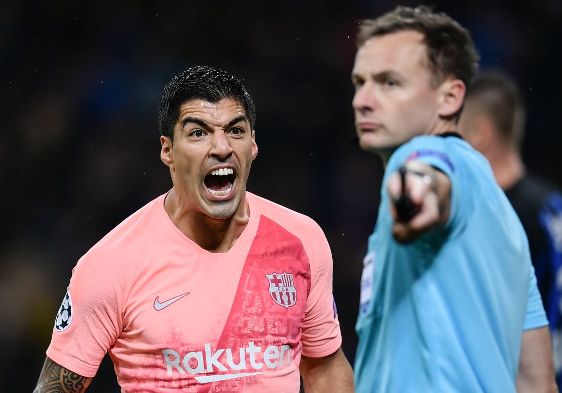 Luis Suarez shouts at an assistant referee at the San Siro stadium in Milan.