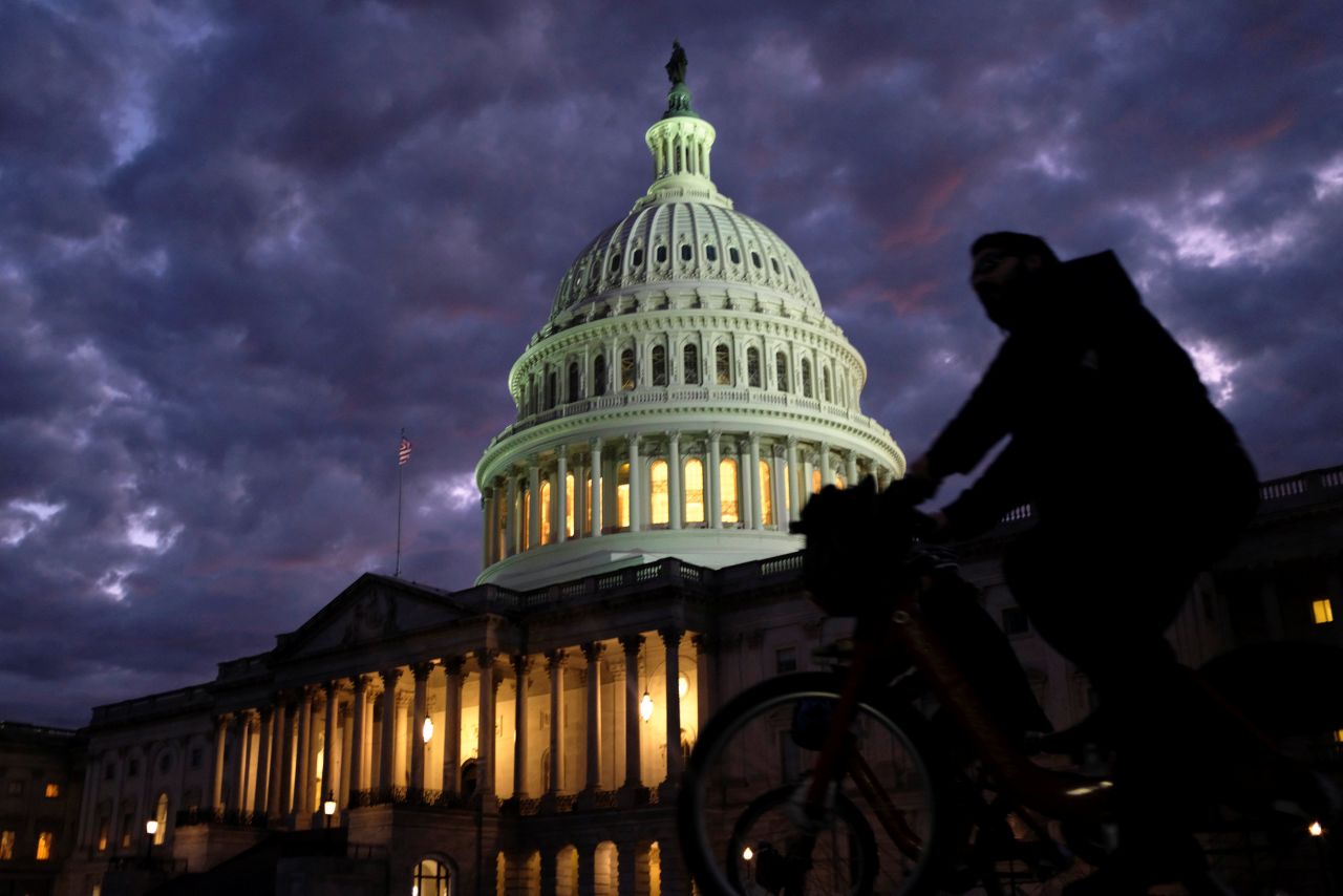 Cyclists ride past the US Capitol on Election Day.