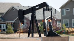 FILE--In this Aug. 16, 2018, file photo a pump jack works in a recently-constructed residential development in Frederick, Colo. Voters in Colorado will consider a proposal to tightly restrict where new oil and gas wells can be drilled in the state in the election on Tuesday, Nov. 6. (AP Photo/David Zalubowski, File)