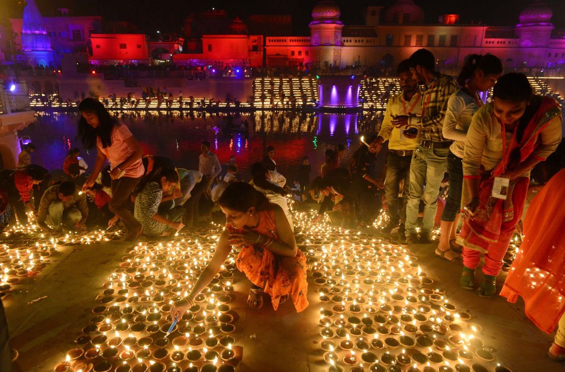 Indian people light earthen lamps on the banks of the River Sarayu on the eve of "Diwali" festival during a "Deepotsav" event organised by the Uttar Pradesh government in Ayodhya on November 6, 2018