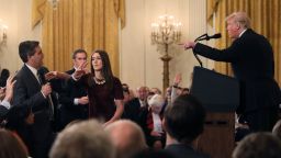 A White House staff member reaches for the microphone held by CNN's Jim Acosta as he questions U.S. President Donald Trump during a news conference following Tuesday's midterm U.S. congressional elections at the White House in Washington, U.S., November 7, 2018. REUTERS/Jonathan Ernst