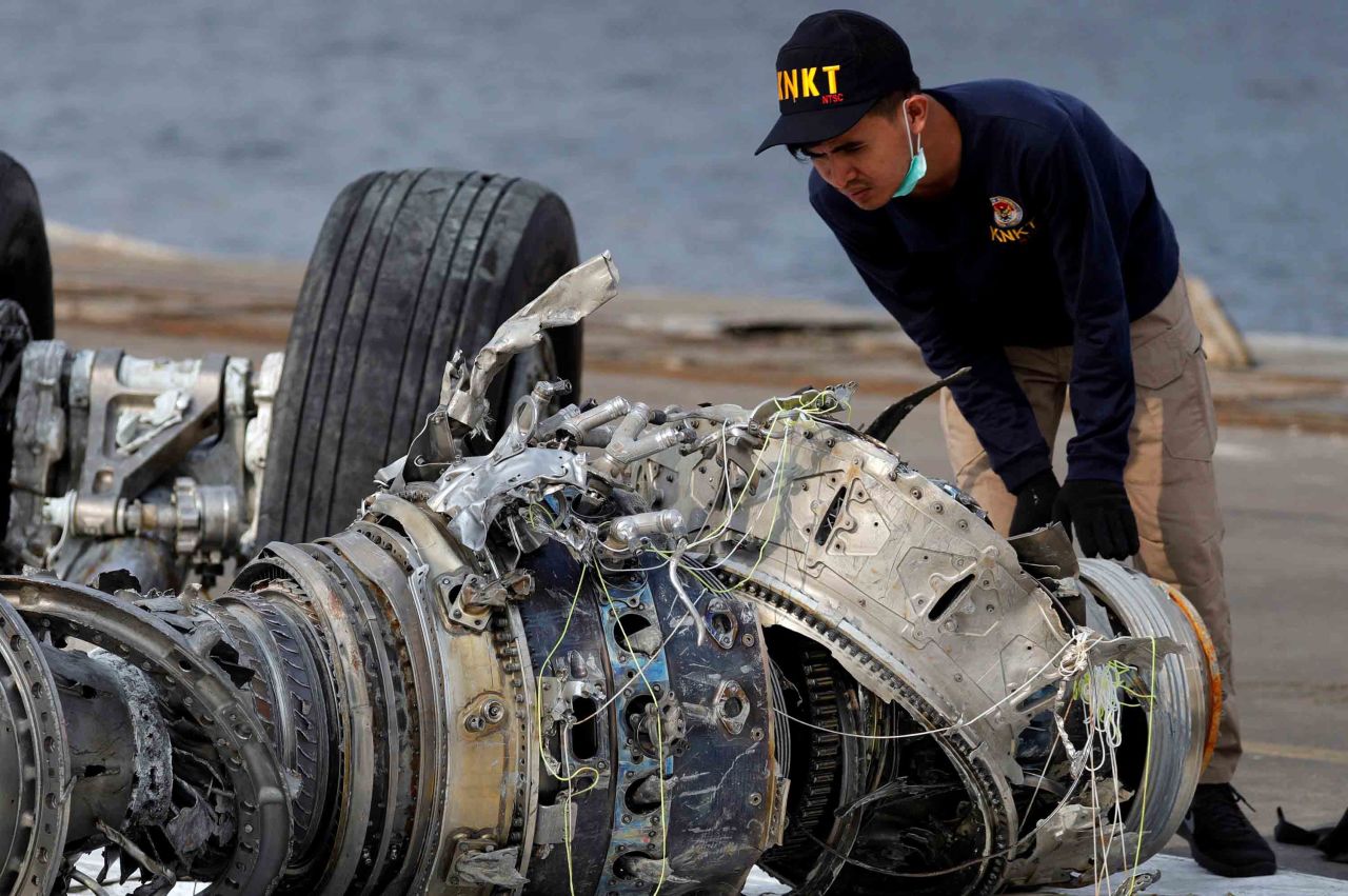 An Indonesian official examines a turbine engine from the plane on Sunday, November 4.