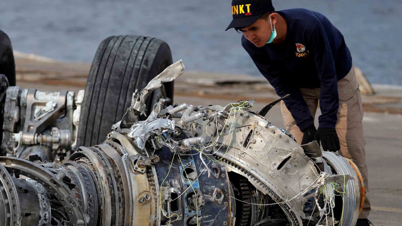 An Indonesian National Transportation Safety Commission (KNKT) official examines a turbine engine from the Lion Air crash.