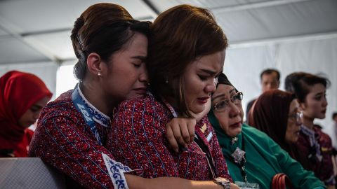 Families and colleagues of victims of Lion Air flight JT 610 cry on the deck of Indonesian Navy ship KRI Banjarmasin during a visit and pray at the site of the crash on November 6, 2018, in Karawang, Indonesia.