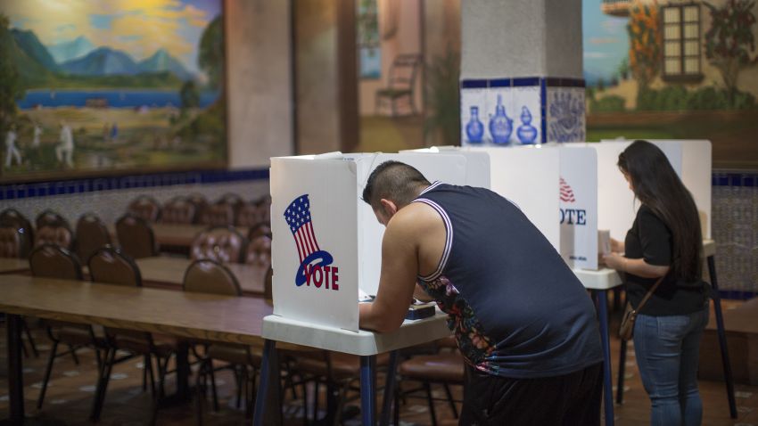 LOS ANGELES, CA - NOVEMBER 08: Latinos vote at a polling station in El Gallo Restaurant on November 8, 2016 in the Boyle Heights section of Los Angeles, California. In addition to choosing between Republican Donald Trump or Democrat Hillary Clinton for President of the United States, Californians are deciding on 17 ballot propositions. (Photo by David McNew/Getty Images)