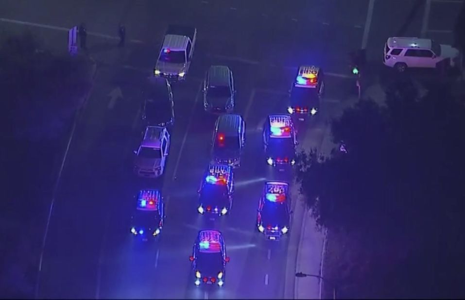 Police vehicles block an intersection near the shooting in an image from aerial video.