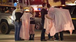 People comfort each other as they stand near the scene Thursday, Nov. 8, 2018, in Thousand Oaks, Calif. where a gunman opened fire Wednesday inside a country dance bar crowded with hundreds of people on "college night," wounding 11 people including a deputy who rushed to the scene. Ventura County sheriff's spokesman says gunman is dead inside the bar. (AP Photo/Mark J. Terrill)