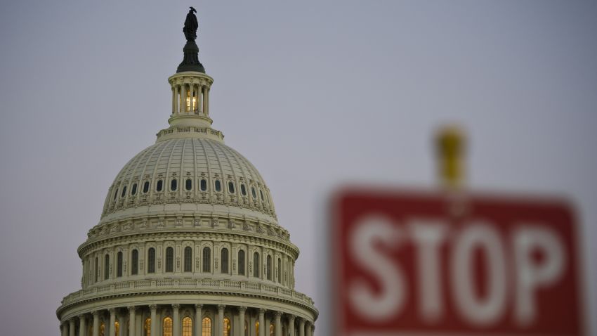 A stop sign is seen at dusk next to the US Congress building on the eve of a possible government shutdown as Congress battles out the budget in Washington, DC, September 30, 2013. AFP PHOTO/ MLADEN ANTONOV        (Photo credit should read MLADEN ANTONOV/AFP/Getty Images)