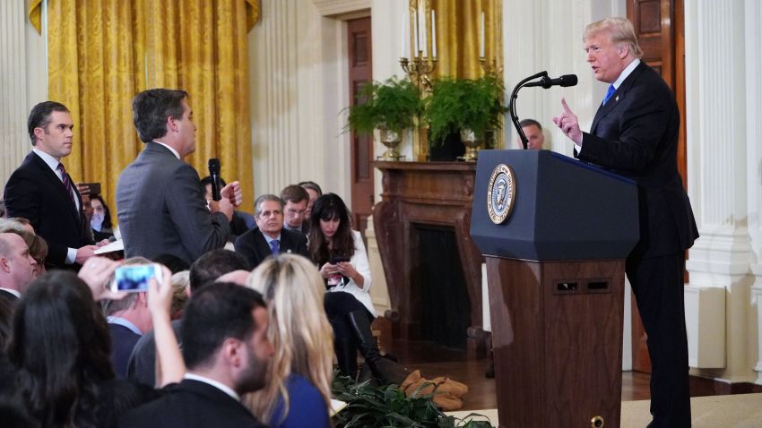 US President Donald Trump (R) gets into a heated exchange with CNN chief White House correspondent Jim Acosta (C) as NBC correspondent Peter Alexander (L) looks on during a post-election press conference in the East Room of the White House in Washington, DC on November 7, 2018. (Photo by MANDEL NGAN / AFP)        (Photo credit should read MANDEL NGAN/AFP/Getty Images)