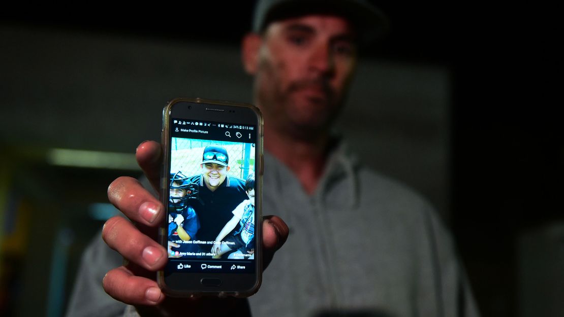 Jason Coffman displays a photo of his son, Cody, who was killed in the shooting at the bar in Thousand Oaks. 