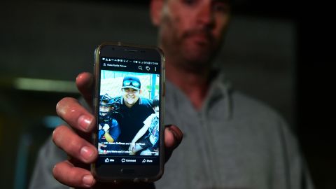 Jason Coffman displays a photo of his son, Cody, who was killed in the shooting at the bar in Thousand Oaks.