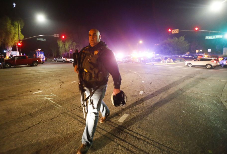  Law enforcement officers guard the road leading to the Borderline Bar and Grill.