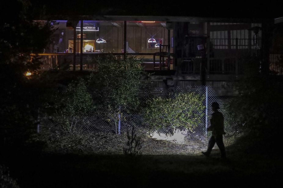 Police work outside the venue where the shooting occurred.