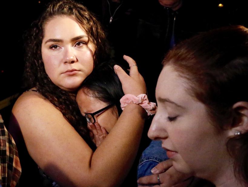 Nellie Wong cries as Chyann Worrell holds her and Erika Sigman, right, stands beside them. All three were inside the Borderline Bar and Grill when shooting started.