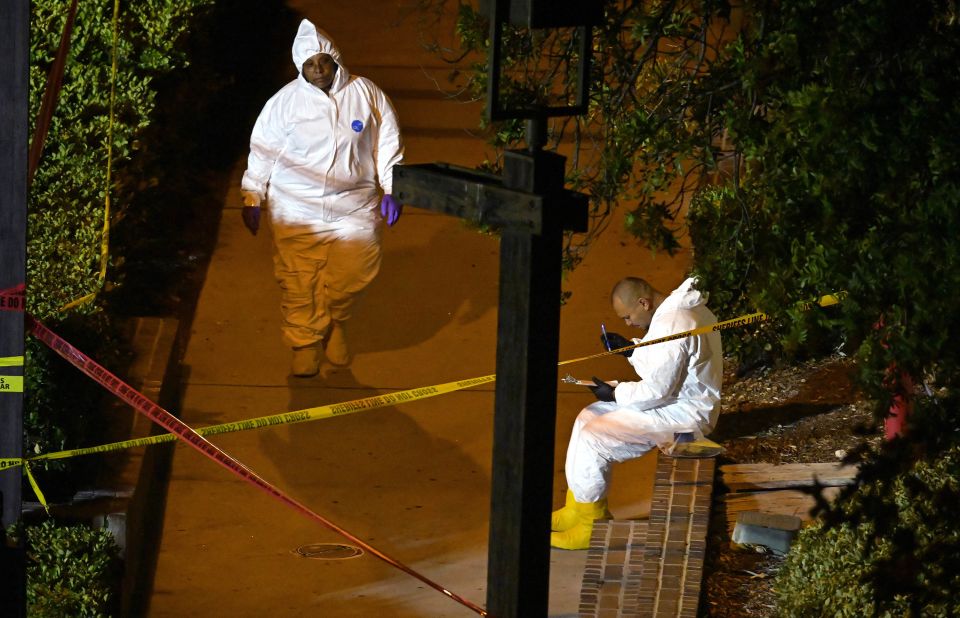 A forensics team collects evidence at the scene.