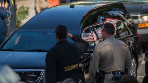 A car in a procession carries the body of Ventura County sheriff's Sgt. Ron Helus.