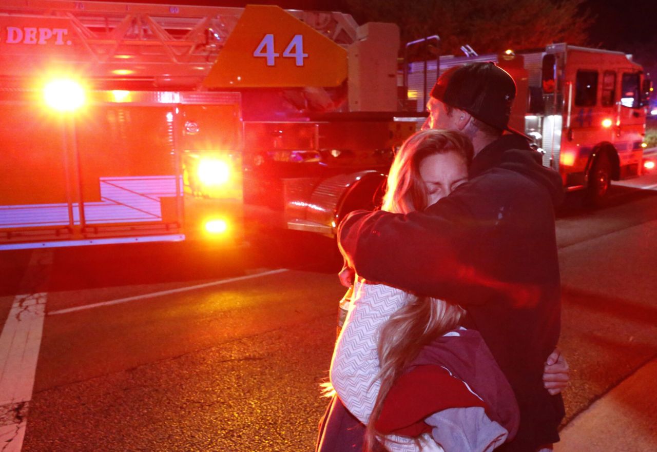 Molly Esterline is hugged by David Crawford on the scene of a shooting at a bar in Thousand Oaks, California, on Thursday, November 8.