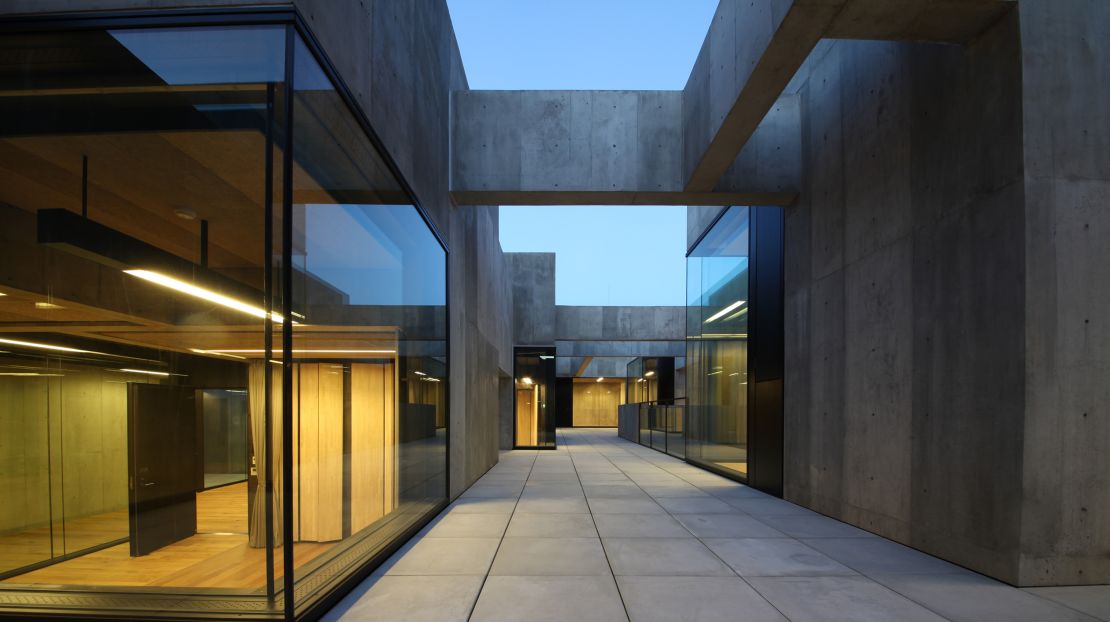 Glass and wood soften the appearance of the building's concrete frame.