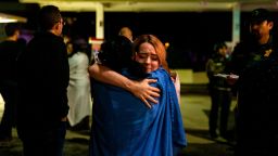 THOUSAND OAKS, CA - NOVEMBER 08:  Two people embrace each other others stand in a gas station parking lot along South Moorpark Road in the aftermath of a mass shooting at Borderline Bar & Grill, on Thursday, Nov. 8, 2018 in Thousand Oaks, California. The gunman burst into the bar around 11:20 p.m., cloaked in all black as he threw smoke bombs and began shooting at targets as young as 18 inside the Borderline Bar & Grill, authorities and witnesses said. (Photo by Kent Nishimura / Los Angeles Times via Getty Images)