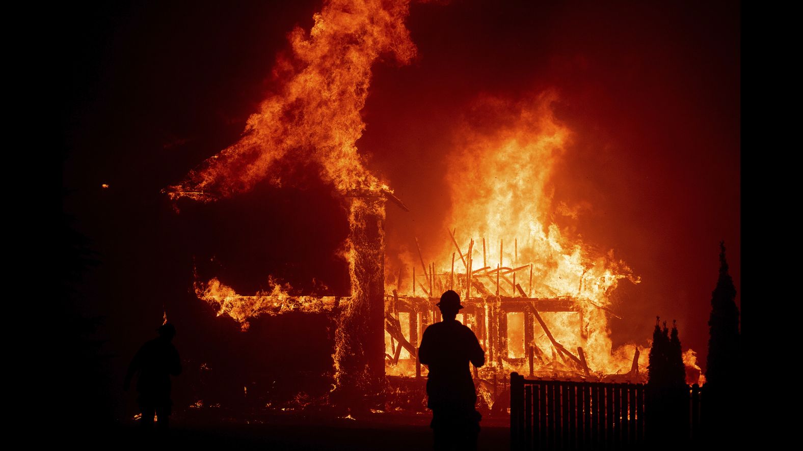 A home burns as the Camp Fire rages through Paradise.